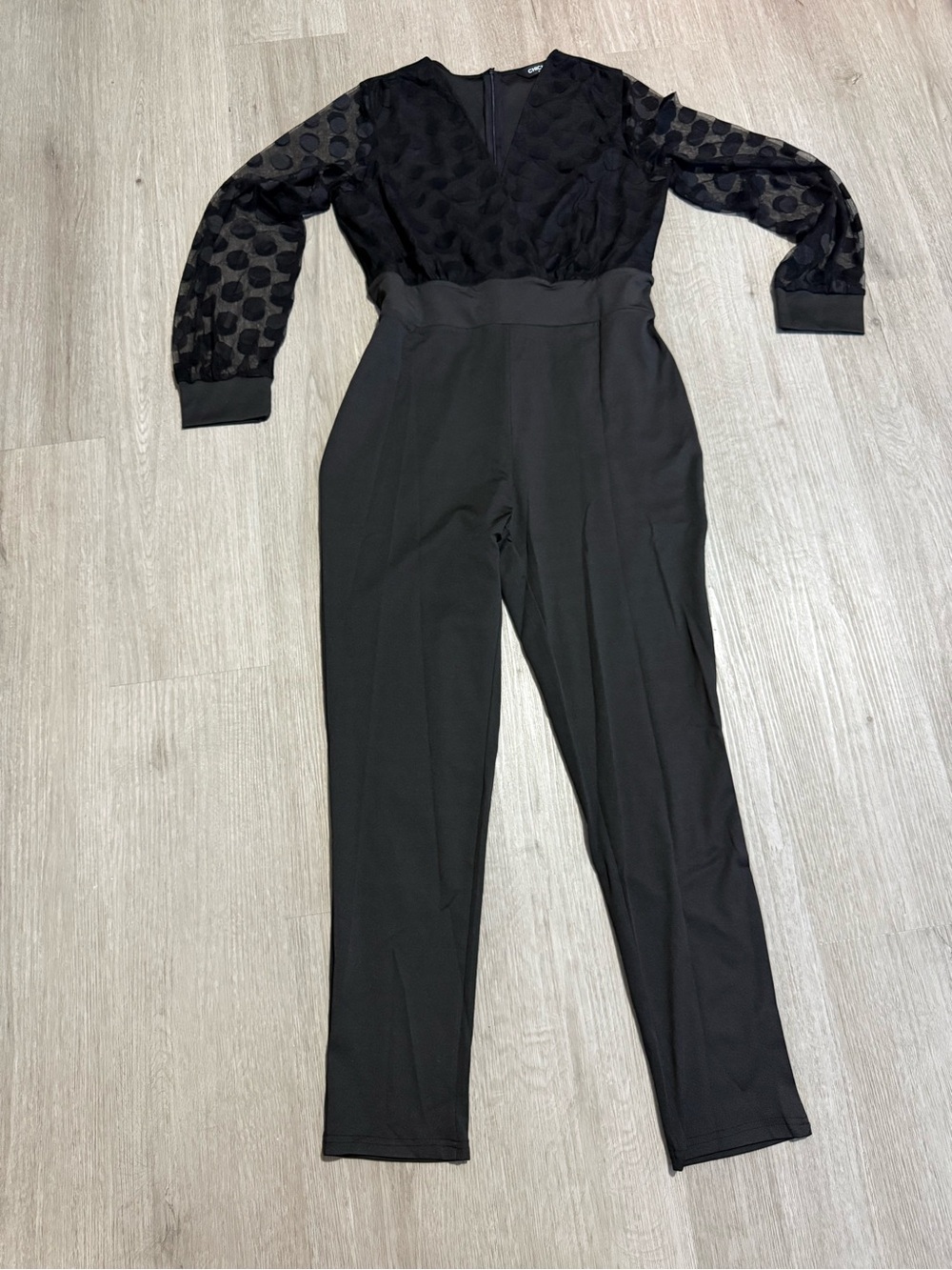 Sleek Black Long-Sleeve V-Neck Jumpsuit with Sheer Dot Sleeves